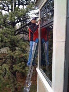 Ryan Olson cleaning large windows
